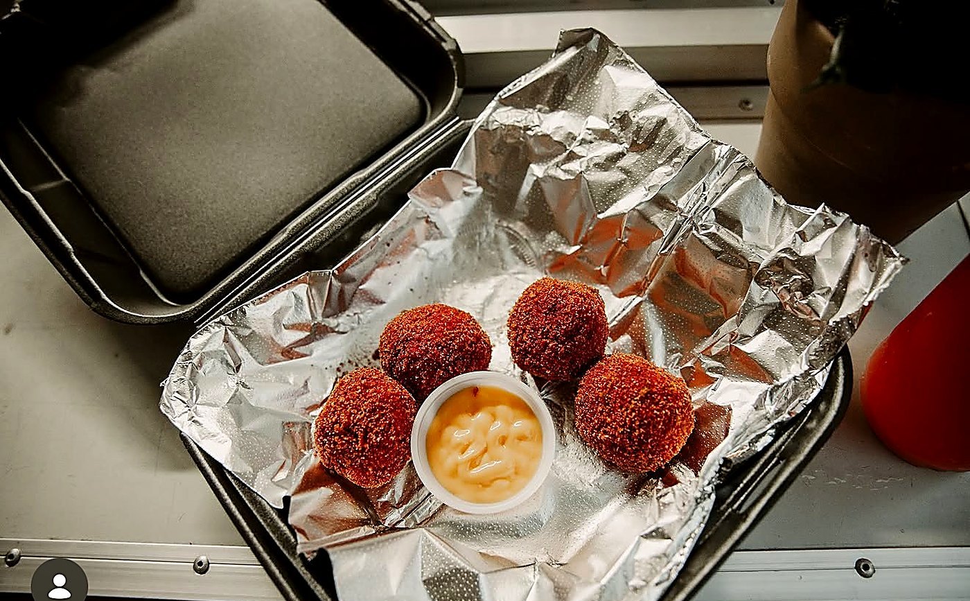 Cheeto Balls in a foil tray with dipping sauce